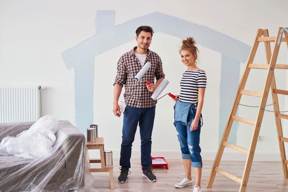 couple painting 2 bedroom house