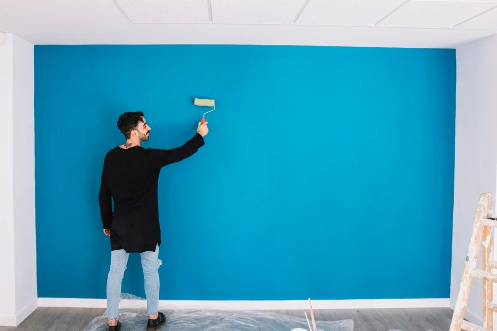 man painting one wall
